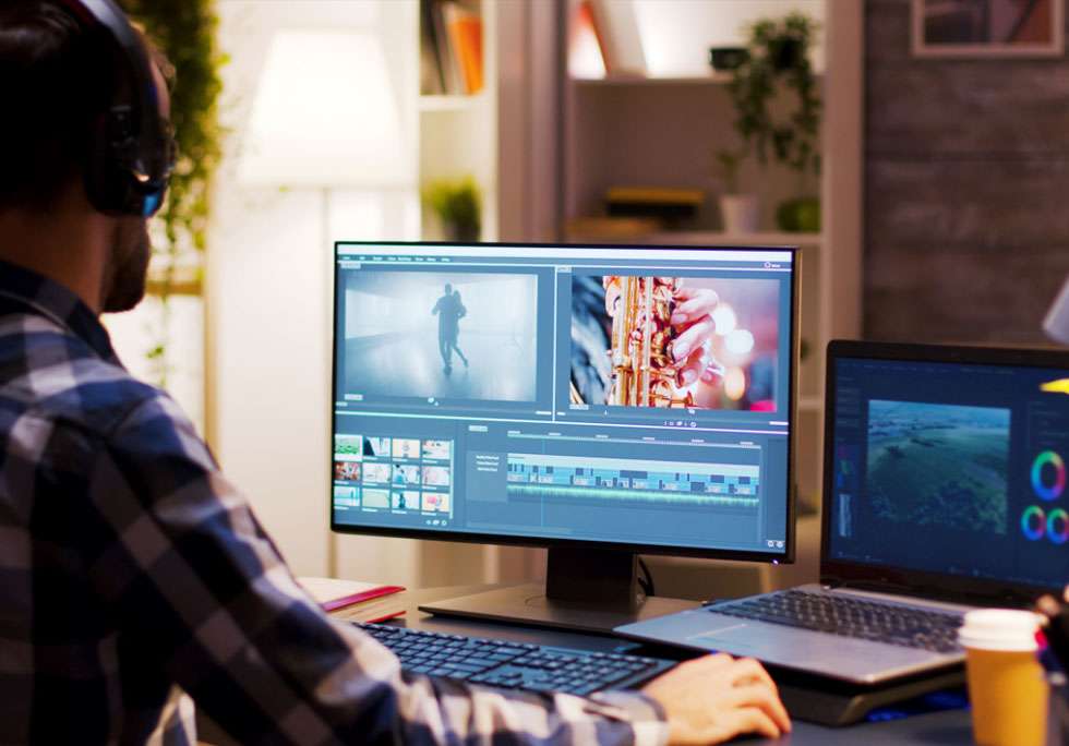 Photo of a guy sitting at computer workstation